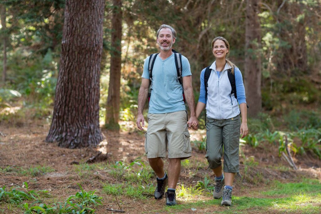 Enjoy active retirement! Active senior couple conquers nature after sacroiliac joint fusion at California Sports & Spine.