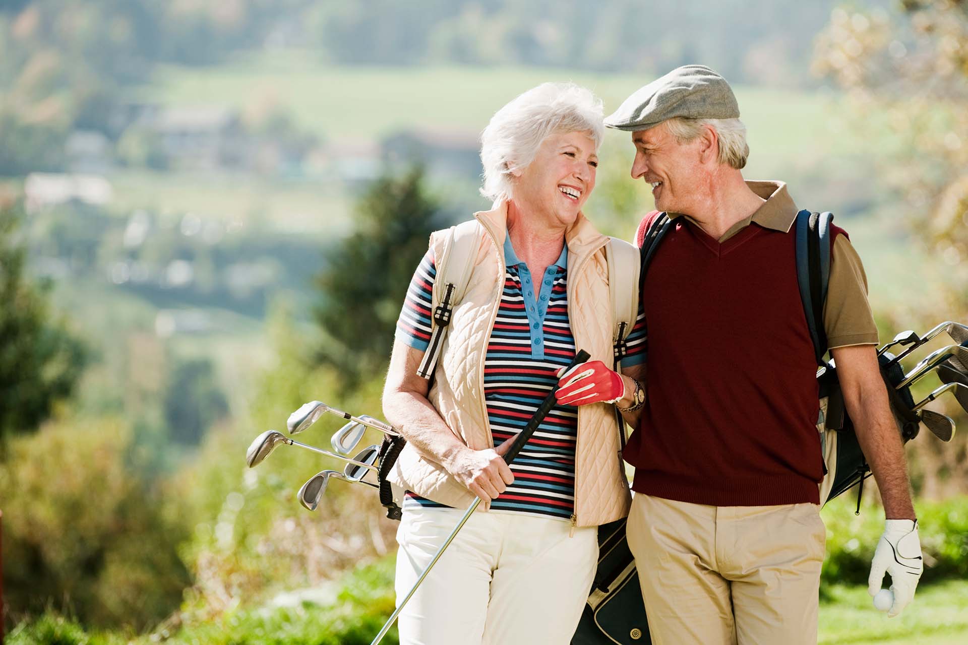 happy retired couple golfing